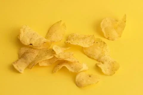 Chips on yellow background close-up Stock Photos