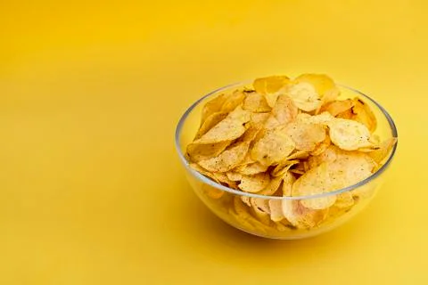 Chips on yellow background close-up Stock Photos