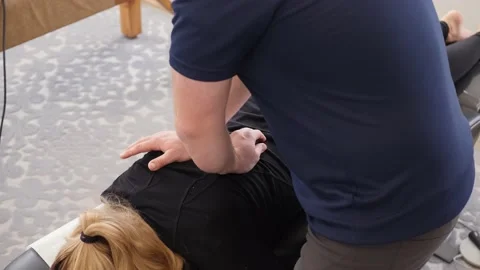 Chiropractor Cracking The Back Of A Female Patient 1 Stock Footage 145943262