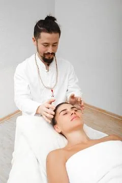 Chiropractor doing energetic head massage. Massage helps transform negative.. Stock Photos