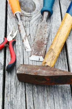 Chisel and a hammer on the old boards Stock Photos