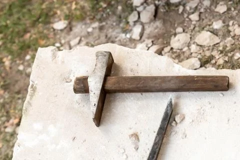 Chisel and hammer stone processing big slab edge, quarry background Stock Photos