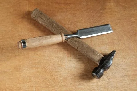 Chisel and hammer on wood. Stock Photos