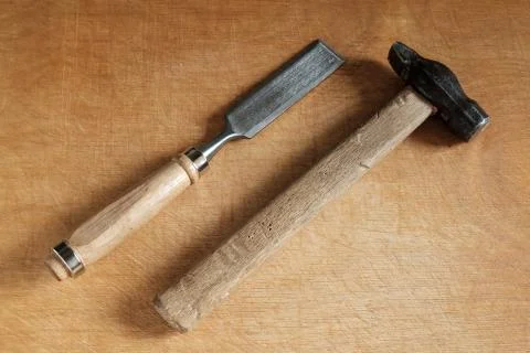 Chisel and hammer on wood. Stock Photos