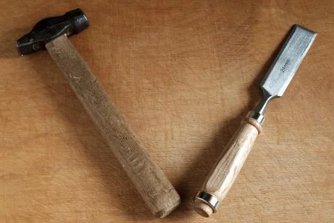 Chisel and hammer on wood. Stock Photos