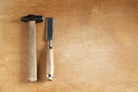 Chisel and hammer on wood. Stock Photos