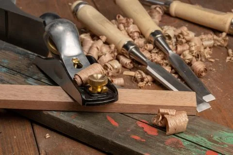 Chisel and small block plane with wood shavings Stock Photos