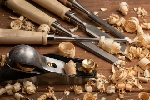 Chisel and small block plane with wood shavings Stock Photos