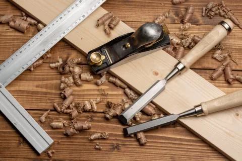 Chisel and small block plane with wood shavings Stock Photos