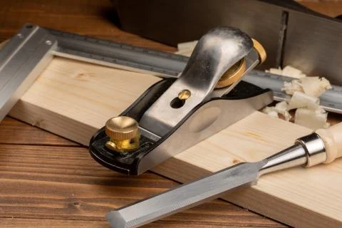 Chisel and small block plane with wood shavings Stock Photos