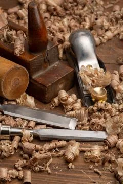 Chisel and small block plane with wood shavings Stock Photos