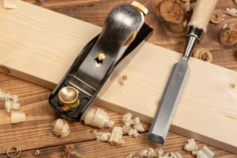 Chisel and small block plane with wood shavings Stock Photos