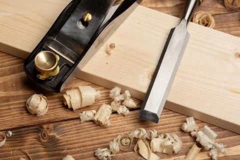 Chisel and small block plane with wood shavings Stock Photos