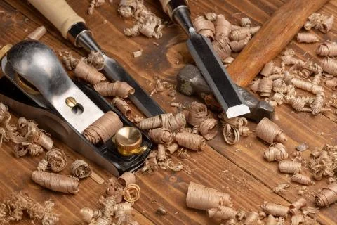 Chisel and small block plane with wood shavings Stock Photos
