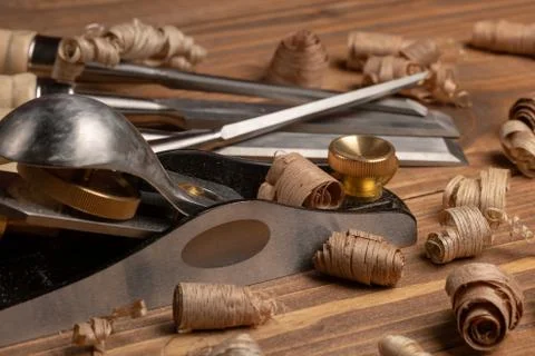 Chisel and small block plane with wood shavings Stock Photos