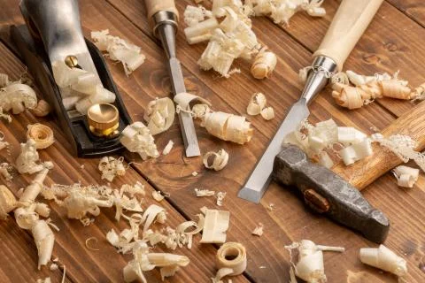 Chisel and small block plane with wood shavings Stock Photos
