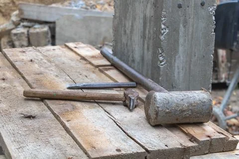 A chisel and two hammers on the work table in the construction site - Constru Stockfoto's