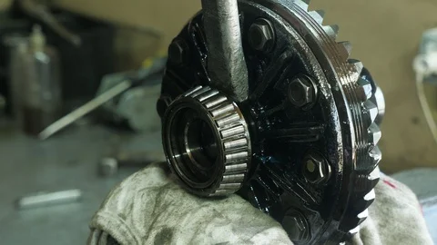 Chisel hitting a transmission device to separate a roller bearing in a workshop Stock Footage 127337723