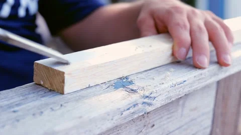 Chisel used to scrape paint off of wooden board. Two slow motion clips. Stock Footage 162360764