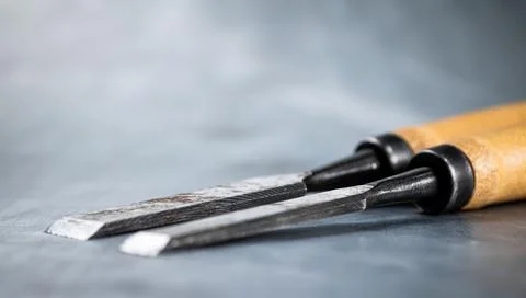 Chisel on wood on the table. Stock Photos