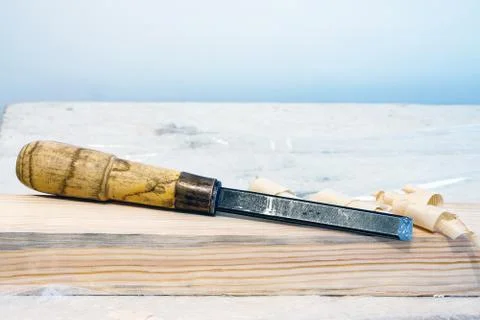 Chisel on a wooden bar Stock Photos