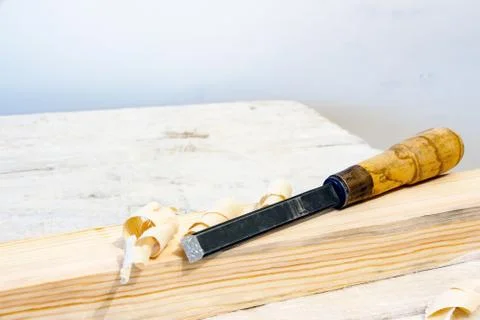 Chisel on a wooden bar Stock Photos