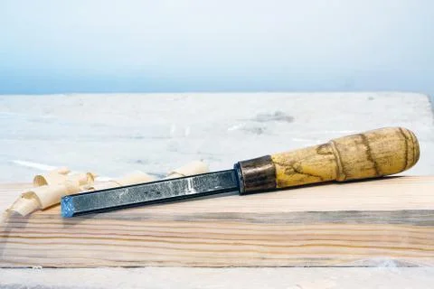 Chisel on a wooden bar Stock Photos