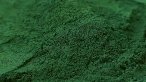 Chlorella or spirulina algae green powder falling down close up Stock Footage 311799092