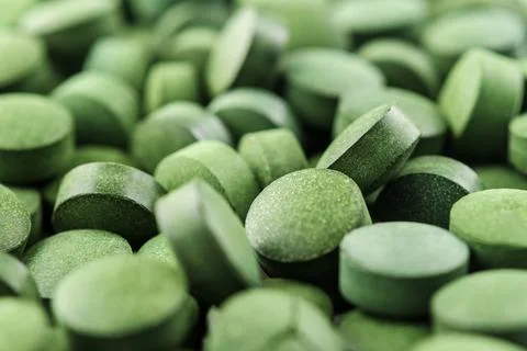 Chlorella or spirulina tablets close up. Texture of tablets spirulina or chlo Stock-Fotos