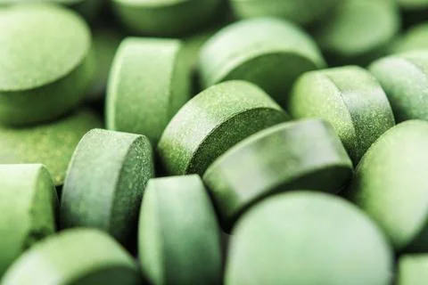 Chlorella or spirulina tablets close up. Top view. Texture of tablets spiruli Stock Photos