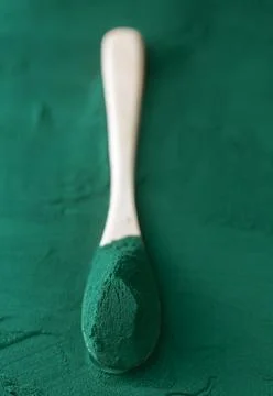 Chlorella single celled green algae. Detox superfood on the wooden spoon Stock Photos
