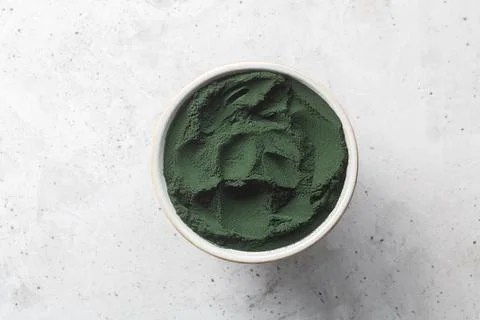 Chlorella single celled green algae. Detox superfood on the concrete backgrou Stock Photos