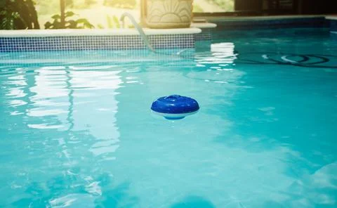 A chlorine float in a swimming pool. Dosing float for swimming pool chlorin.. Stock Photos
