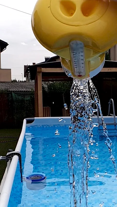 Chlorine floater pulled out of an above ground swimming pool in slowmotion Stock Footage 137573806