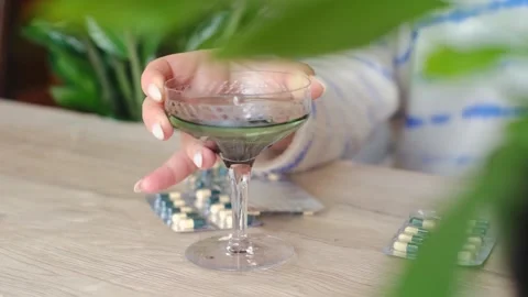 Chlorophyll bottle stands on the table surrounded by lush green plants, promotin Stock Footage 267229307