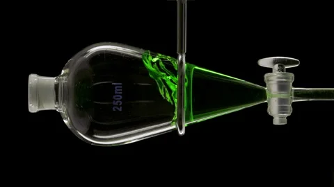 Chlorophyll solution injected forming striking splash in funnel Stock Footage 325352866