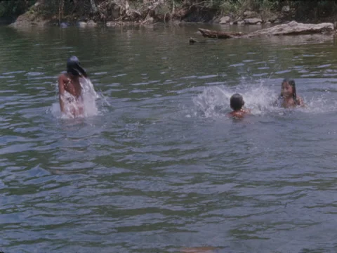 Choco Indian children splash and play in a jungle river in Panama. Stock Footage 148126596
