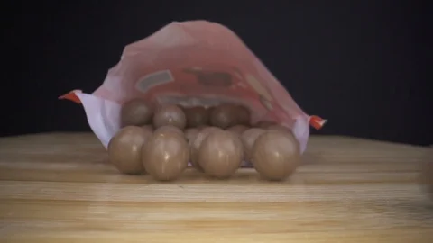 Chocolade candy bag falling down on table macro closeup Video stock 124018168