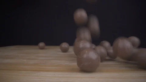 Chocolade Candy falling down on table and bouncing in wide macro closeup Stock Footage 124018192