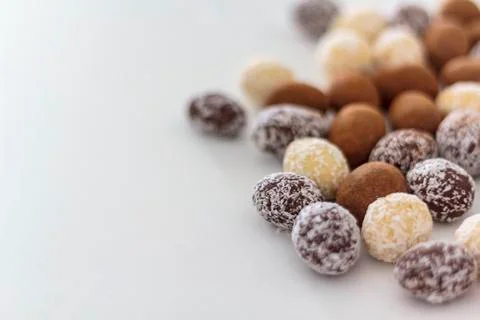 Chocolate almonds on white table Stock Photos