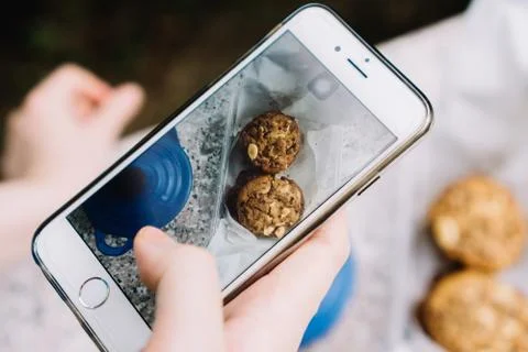 Chocolate and almond home made cookies in mobile screen Stock Photos
