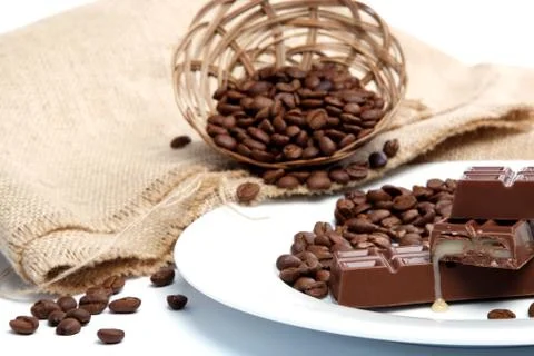 Chocolate and coffee beans on sacking. Stock Photos