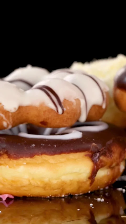 Chocolate and Iced Donut Dropping Onto Dessert Stack 動画素材 315423488