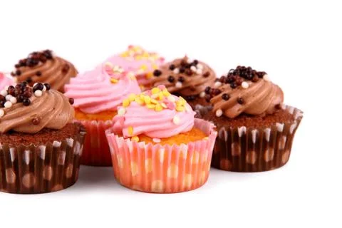 Chocolate and pink cup cakes with deco balls Stock Photos