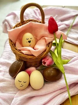 Chocolate And Smiley Eggs In Easter Basket Stock Photos
