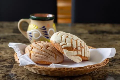 Chocolate and vanilla bread in front of a traditional Mexican cup of coffee.. Stock Photos