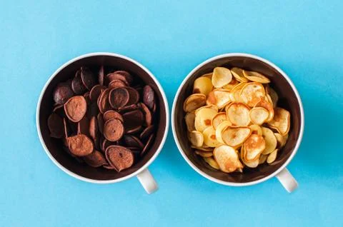 Chocolate and vanilla tiny pancake cereals in a bowls. Stock Photos
