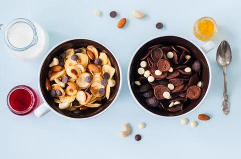 Chocolate and vanilla tiny pancake cereals in a bowls. Stock Photos