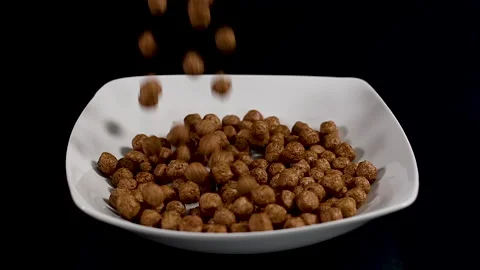Chocolate balls falling on white plate.Slow motion Video stock 140232819