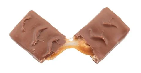 The chocolate bar is broken into two halves. Bar with nuts, nougat and carame Stock Photos